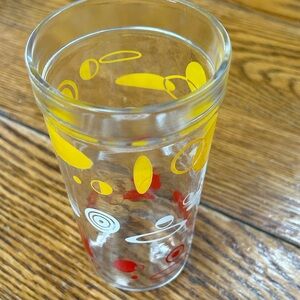 Atomic pattern Mid Century Modern tumbler.  Red, yellow and white spirals.